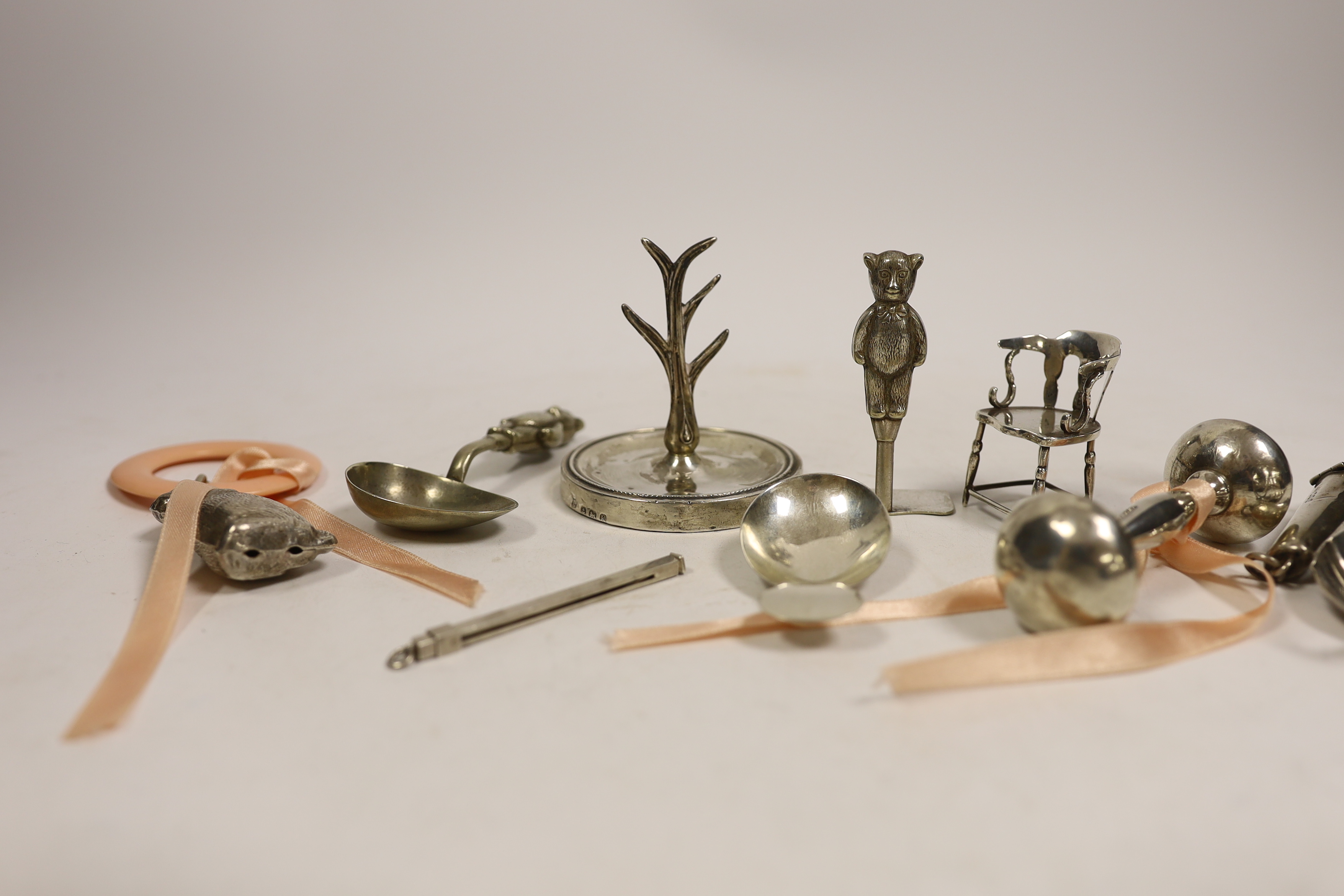 A collection of small silver including an Edwardian silver miniature model 'Dickens 1812-1870' chair, Levy & Salaman, Birmingham, 1910, 46mm, a Georgian silver caddy spoon, a Geoffrey G. Bellamy silver leaf caddy spoon,